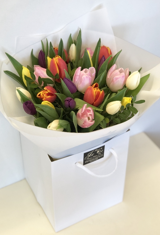 Bouquet solely made of english grown spring tulips, Hand tied in water with luxury wrap and bag. 