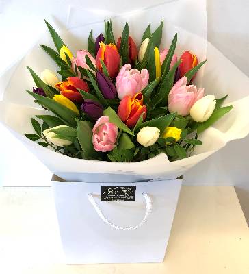 Bouquet solely made of english grown spring tulips, Hand tied in water with luxury wrap and bag. 