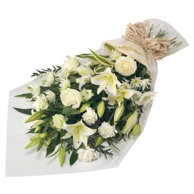 Flat bouquet including a mix of all white flowers and finished with a bow. 