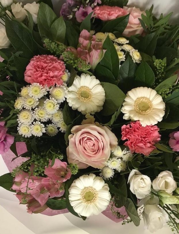 Natural hand tied bouquet in soft tones including roses, germini, lizianthus and chrysanthemums.