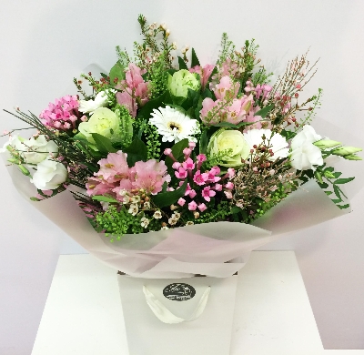 Hand tied bouquet natural in style including bouvardia, wax flower, broom and lizianthus. 