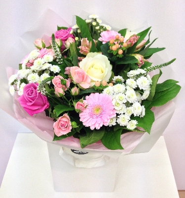 Pink and white mixed bouquet including veronica, roses and hypericum berries. 