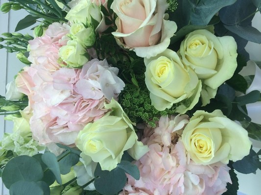 Luxury bouquet of pale pink hydrangea and roses, white rose and lisianthus and finished with eucalyptus and large glass vase. 