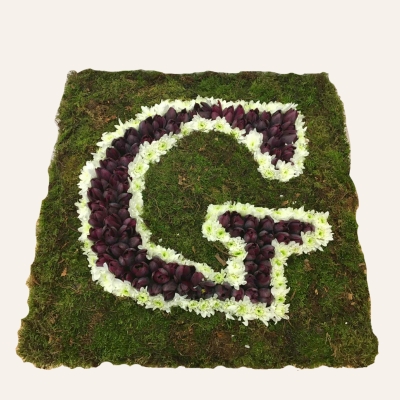 Letter-shaped funeral tribute on a 24