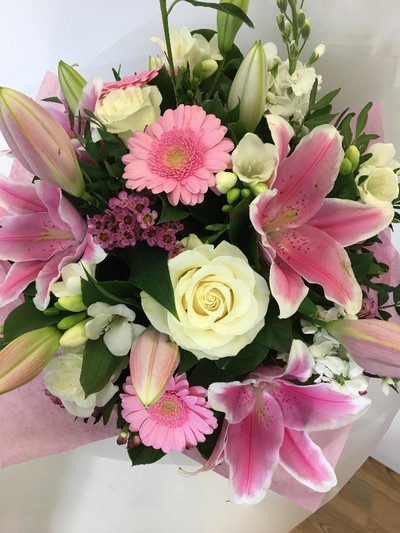 Luxury hat box bouquet including mixed pink tones. Scented flowers such as roses, lily, wax flower and freesia. 