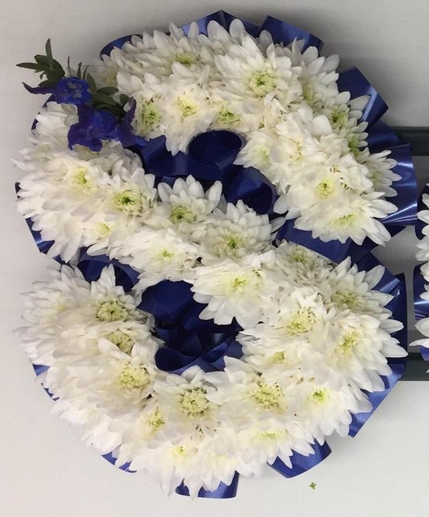SON Funeral lettering with white chrysanthemum base and deep blue focal and ribbon edging. 