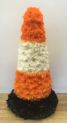 Traffic cone funeral tribute created with chrysanthemum and spray paint detailing. 