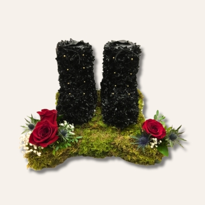 3D Army Boots funeral tribute styled as black military boots with ribbon laces, gold button detail, army badge and red, white and blue floral focal, 17 x 17 inch base, 18 inch height, customisable flower colours.