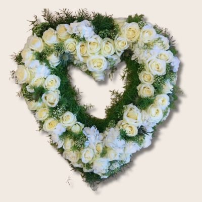 Heart of Manchester funeral tribute made of pure white roses and hydrangea. 