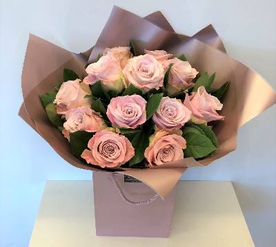 12 Light pink roses, with complimenting foliage's and wrapped in rose gold cellophane and gift bag.