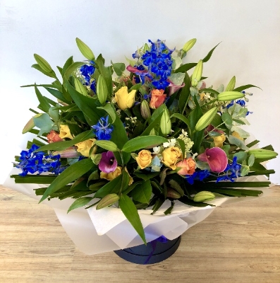 Luxury hand tied of lily, calla lily, delphinium and roses. 