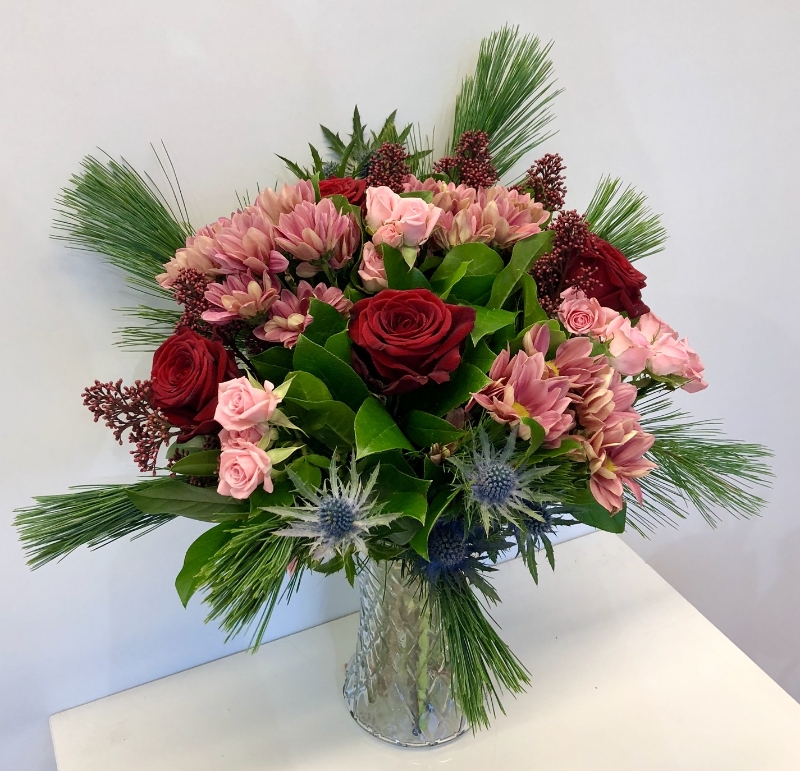 This bouquet is a stylish mix of pinks and red in a glass vase with zero plastic. 