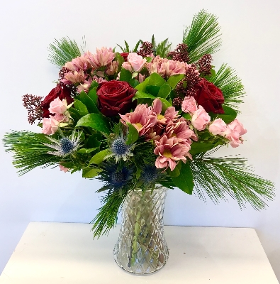 This bouquet is a stylish mix of pinks and red in a glass vase with zero plastic. 