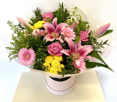 Bright and refreshing bouquet with chrysanthemums, lilies, roses, solidago, germini, and stocks, complemented by eucalyptus and wrapped in luxury cellophane with a hatbox presentation.