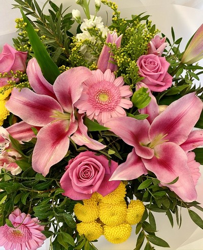 Bright and refreshing bouquet with chrysanthemums, lilies, roses, solidago, germini, and stocks, complemented by eucalyptus and wrapped in luxury cellophane with a hatbox presentation.
