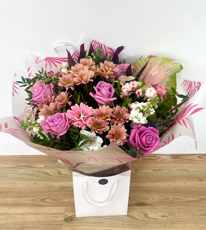 This bouquet is extra in itself, glitter, butterfly's and ribbons make the roses, germini and anthuriums in this design pop. 