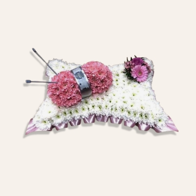 Knitting funeral tribute floral design including actual knitting needle accent available in a variety of colours.