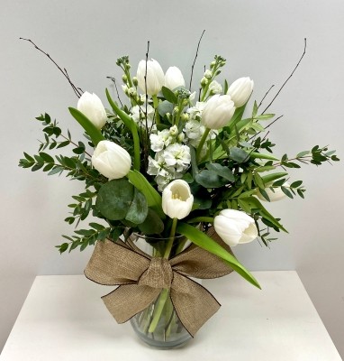 Stunning white bouquet filled with the freshest crisp white tulips and scented stocks finished with mixed foliage and natural birch twigs. Design comes in a modern glass vase and presented in our signature gift bag. 