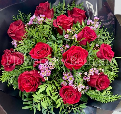 Dozen luxury red roses with fresh-scented wax flowers, accented with diamanté and complementary foliage, wrapped in luxury cellophane and matching gift bag, hand-tied in water.