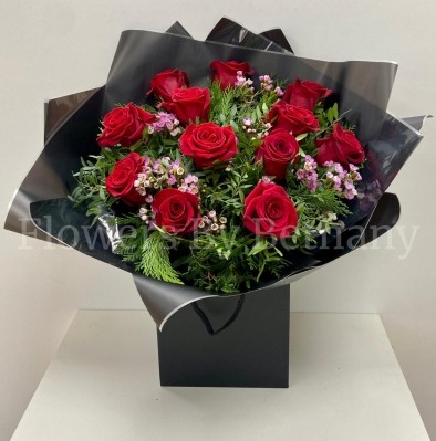 Dozen luxury red roses with fresh-scented wax flowers, accented with diamanté and complementary foliage, wrapped in luxury cellophane and matching gift bag, hand-tied in water.