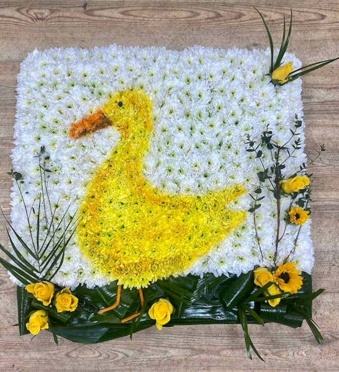 Stunning duck funeral tribute made with fresh chrysanthemum and spray paint detailing bringing the design together. 