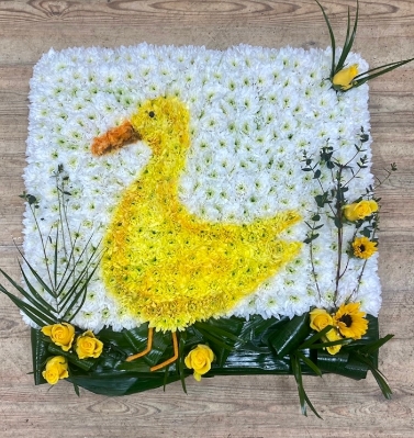 Stunning duck funeral tribute made with fresh chrysanthemum and spray paint detailing bringing the design together. 