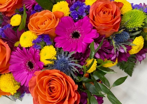 Stunning mixed floral star funeral tribute including roses, chrysanthemum, thistle and mixed foliage. 