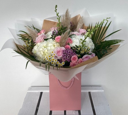 Boho barbie bouquet filled with pink and white florals and finished with pampas grass all hand tied in water. 