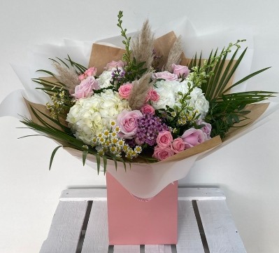 Boho barbie bouquet filled with pink and white florals and finished with pampas grass all hand tied in water. 