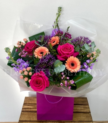 Peach and purple bouquet including allium, roses, germini, wax flower, stocks and more. Hand tied in water and presented in a gift bag. 