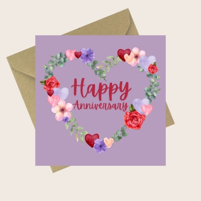 Purple Happy Anniversary card with a floral and heart-shaped wreath design.