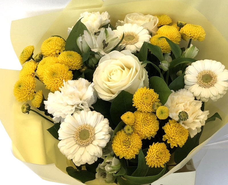 Mixed hand tied of roses, germini and chrysanthemum in yellows and whites. 