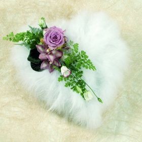 Heart-shaped funeral tribute made of soft white feathers, accented with lilac flowers and mixed foliage.