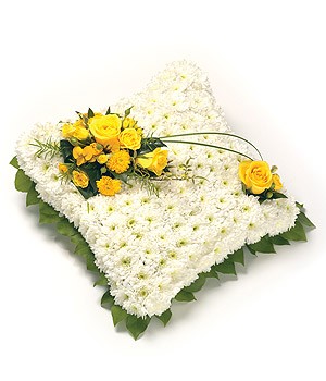 Classic massed cushion funeral tribute created using chrysanthemums and other seasonal flowers. 