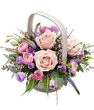 Pink and lavender basket arrangement including roses, Veronica and foliage. 