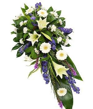 White and purple single-ended funeral spray with seasonal florals and vivid green foliage.