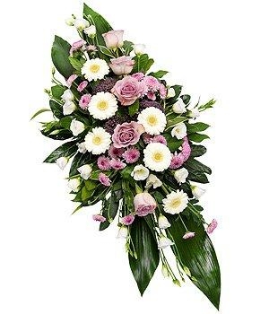 Double-ended spray with lilac and white seasonal blooms and complementary foliage.