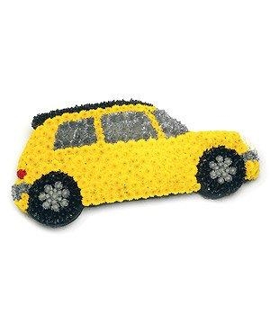 Yellow motor car funeral tribute made with chrysanthemum and spray paint details. 