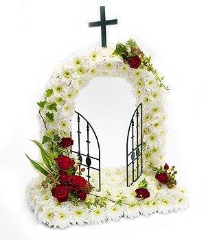 Open gates of heaven funeral tribute with red rose focal flowers. 
