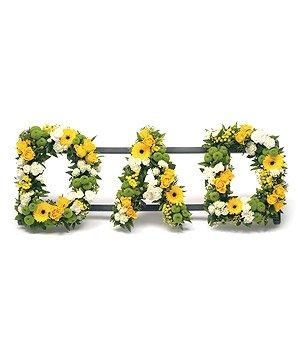 Mixed yellow and green DAD funeral tribute including roses, germini and carnations. 