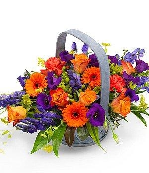 Vibrant basket arrangement including roses, carnation and lisianthus. 