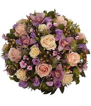Luxury funeral posy with pink, lilac, and white seasonal flowers, complemented by elegant foliage.
