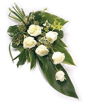 Elegant rose funeral spray with complementary greenery.
