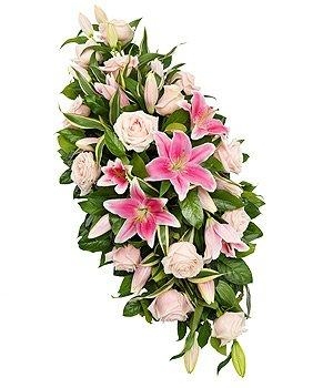 Luxury soft pink rose and lily casket spray with delicate foliage.