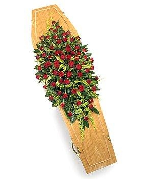 Classic full red rose casket spray with mixed complimentary foliage. 