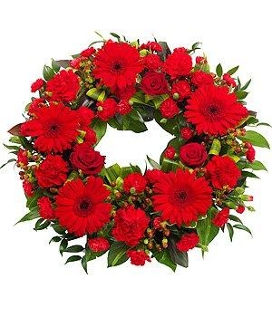 All red funeral wreath including roses, germini and carnation. 