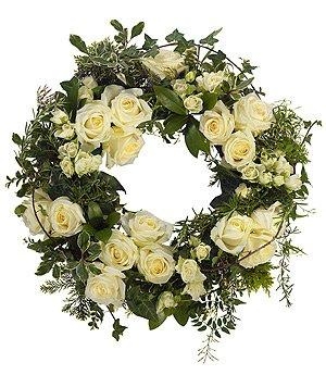 Luxury white rose funeral wreath with mixed foliage. 