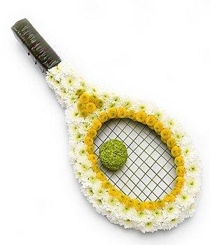 Tennis racket funeral tribute created with massed chrysanthemum and leaf wrapped handle. 