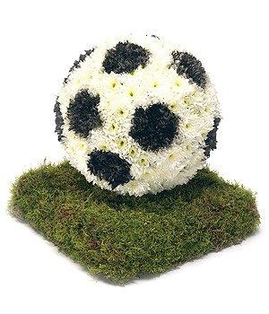 3D Football funeral tribute with black hexagonal print on a turf effect base. 