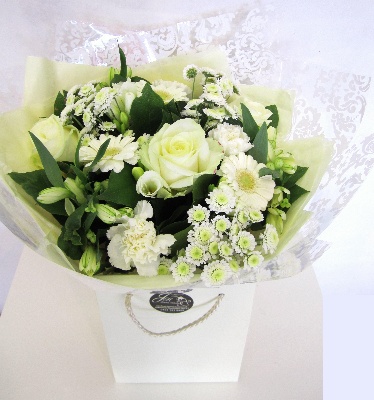 Bouquet made of pure white flowers, including roses, germini, carnations and chrysanthemums. 